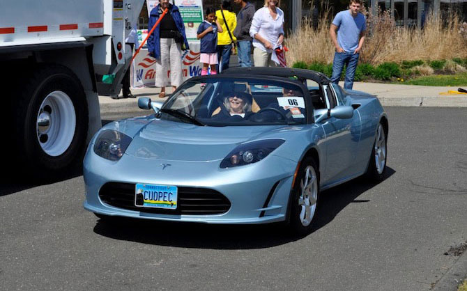 C.U. OPEC! is the license plate on this Tesla Roadster.