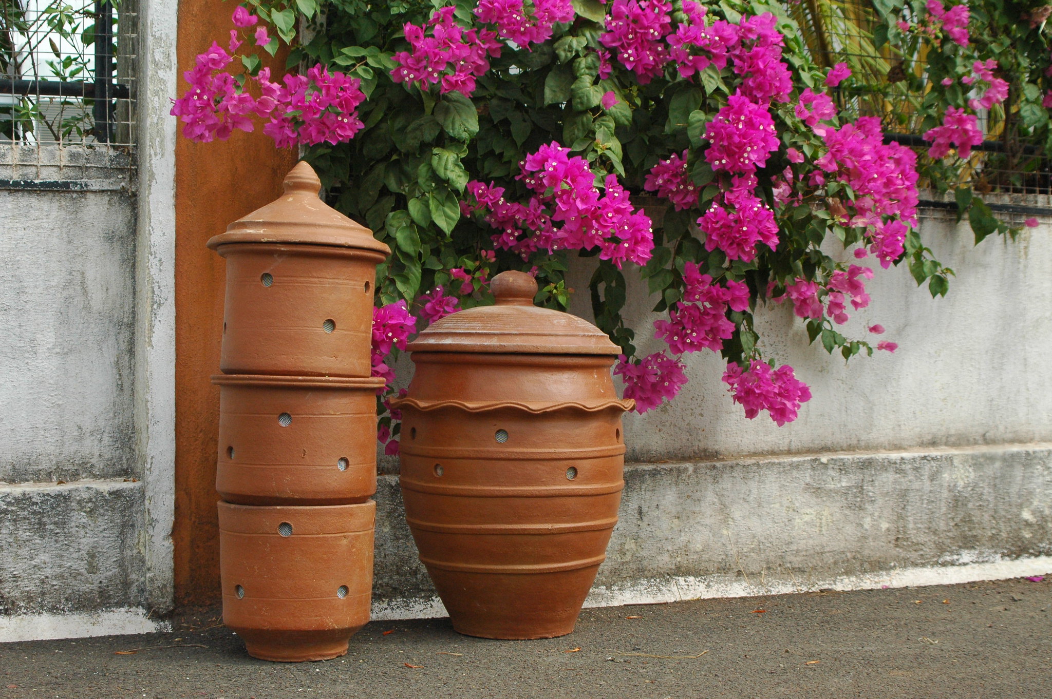 A pair of traditional Indian terracotta composters.