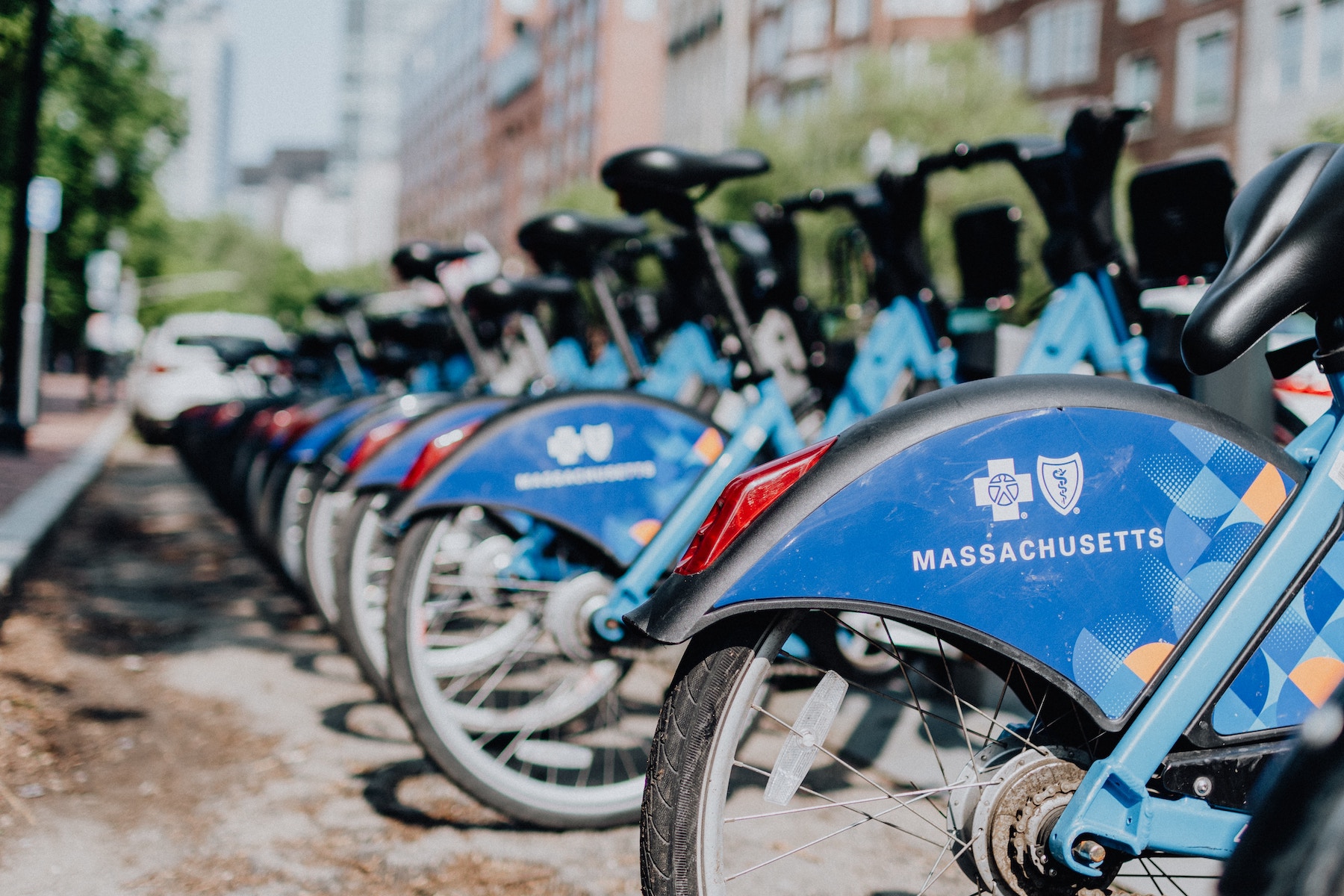 A row of Massachusetts bikes parked in a bike-share station